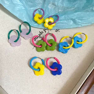Colorful floral resin earrings with dopamine style charms on vibrant metal hoops