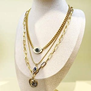 Three-layer gold stainless steel necklace with evil eye and hand of fatima pendants