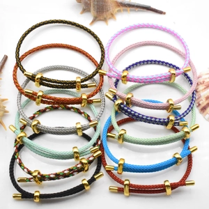 Detail shot of multi-color braided steel wire bracelets with golden infinity clasps