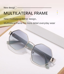 Detail of silver polygon sunglasses with grey gradient lenses on a minimalist stand