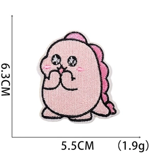 Detail of pink cartoon dinosaur embroidery patch with dimensions 6.3cm x 5.5cm