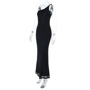 Detail of a black sequined one-shoulder maxi dress with a shimmering slim fit and backless cut