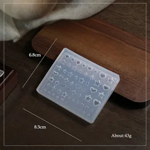 Macro shot of 3D silicone nail art mold featuring star and heart patterns for DIY embossing