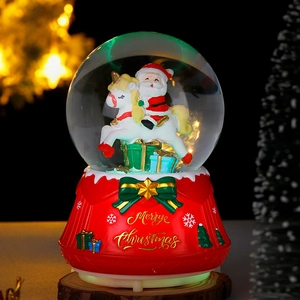 Luminous Christmas crystal ball with Santa Claus on a rocking horse and a red base