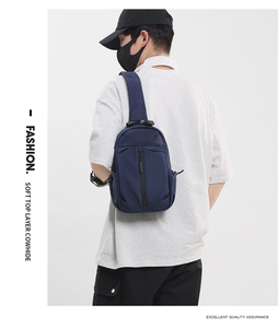 Detail of dark blue top layer cowhide chest bag shown on model for a modern sporty look