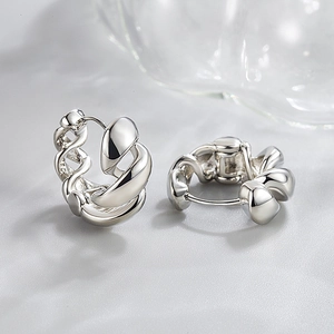 Minimalist silver twisted hoop earrings with a high-polish metallic spiral design