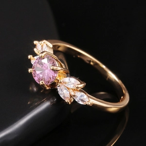 Macro shot of a floral cluster ring with pink gemstone and white marquise zircons