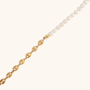 Detail of asymmetrical necklace with gold coffee bean links and lustrous white pearls
