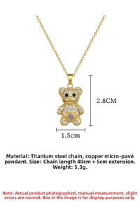 Close-up of gold titanium steel necklace featuring a crystal-encrusted bear pendant