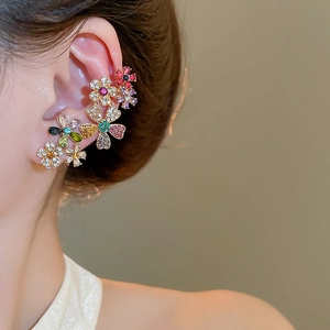 Macro detail of 18k gold plated floral ear cuff featuring vibrant colorful zircon stones