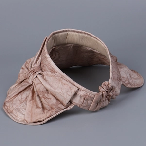 Detail of pink-brown sun hat with tencel floral texture and large decorative bow