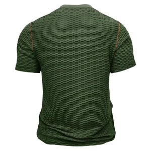 Détail d'un t-shirt vert foncé en maille gaufrée avec coutures contrastées rouge-brun à l'épaule