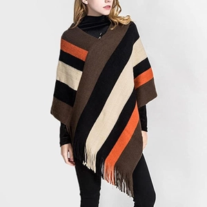 Detail of colorful knitted poncho featuring retro stripes and elegant tassel fringe trim