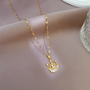 Luxury gold-plated crown heart necklace with micro-paved zircons on grey fabric