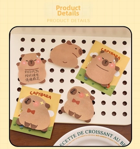 Close-up of cute Capybara shaped sticky notes with various expressions on warm background