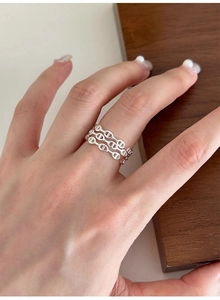Close-up of a triple-layered sterling silver anchor chain open ring on a model hand