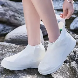 Waterproof white silicone shoe covers worn on rocks near stream showing anti-slip grip