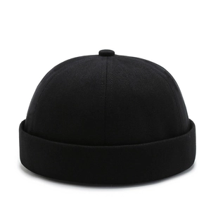 Minimalist black docker brimless cap in cotton twill fabric with six-panel dome design