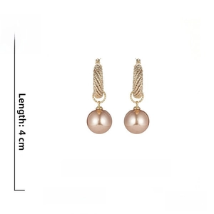 Detailed view of champagne pearl earrings with gold-textured metal hoops, 4cm length