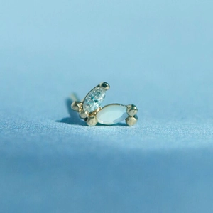 Macro view of gold S925 silver stud with marquise opal and sparkling diamond setting