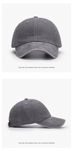 Detailed close-up of dark grey washed cotton baseball cap with vintage canvas texture