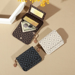 Detail view of foldable monogram card holder with ID window and gold metal keychain
