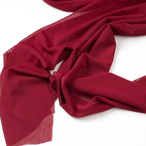 Detailed close-up of dark red mesh fabric layers showing translucent mesh texture