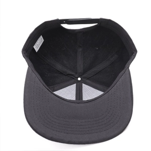 Interior view showing the adjustable strap and label of the black snapback baseball cap