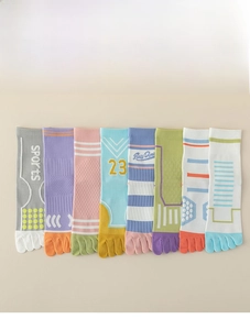 Flat lay of eight pairs colorful cotton five-finger socks with sports stripe details