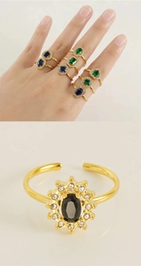 Detail view of gold adjustable rings featuring colorful zircon stones in vintage style