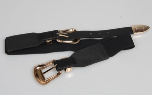 Close-up of black elastic waist belt with ornate gold metallic buckle and retro PU leather detail