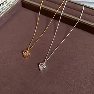 18k gold plated hollow square pendant necklace with cubic zirconia on jewelry tray