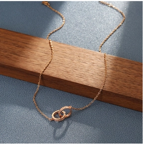 Detail of rose gold double interlocking rings necklace featuring sparkling pavé crystals