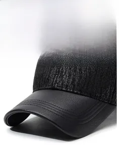 Detailed close-up of a men's black PU leather baseball cap with reinforced stitching
