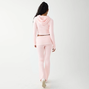 Rear view of pink knitted two-piece set featuring a cropped hoodie and flared pants