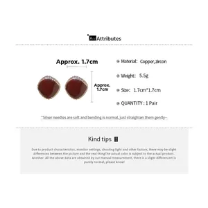 Detailed view of red zircon stud earrings with product dimensions and material specs