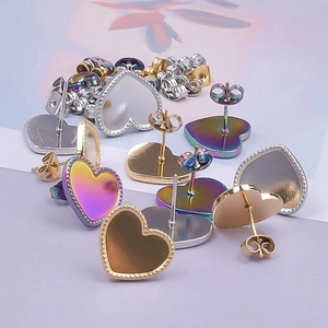 Macro shot of heart-shaped stainless steel earrings with beaded edges in assorted colors
