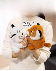 Close-up of cute plush tiger slap bracelets in white and orange with soft faux fur
