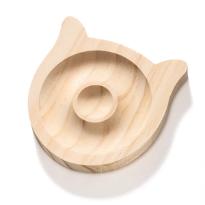 Close-up of cat-shaped solid wood jewelry tray with natural grain and smooth carved groove