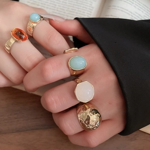 Close-up of vintage geometric rings with colorful amber and blue resin stones