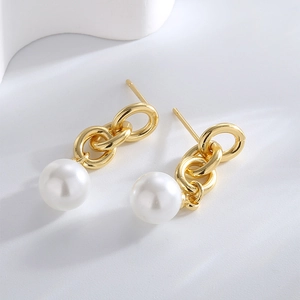 Elegant gold brass pearl drop earrings featuring interlocking rings in a minimalist style