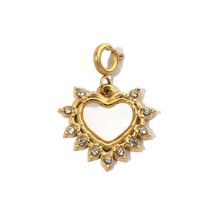 Detailed close-up of golden heart pendant with mother of pearl and sparkling crystals