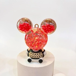 Luminous bear figurine keychain with floating stars in a crystal acrylic sand bottle