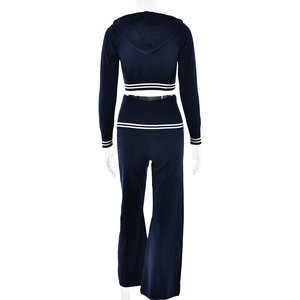 Rear view of navy blue knitted tracksuit featuring white stripes on cuffs and hem