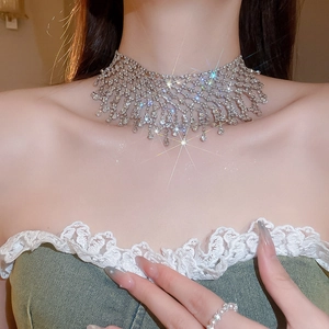 Detail of silver choker necklace featuring cascading rhinestone tassels and a wide band