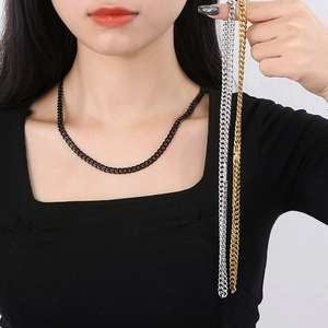 Minimalist Cuban link necklace in black, gold and silver finishes on a model