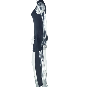 Detail view of black slim-fit mini dress with high neck and decorative side ribbons