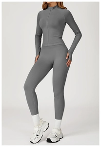 Close-up of charcoal gray seamless knitted yoga jacket with thumbholes and zipper