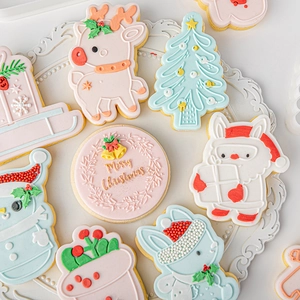 Christmas cookies with reindeer and snowman shapes on a white embossed plate