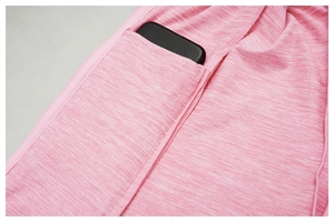 Detail of pink space-dye yoga leggings featuring a functional side pocket for a smartphone